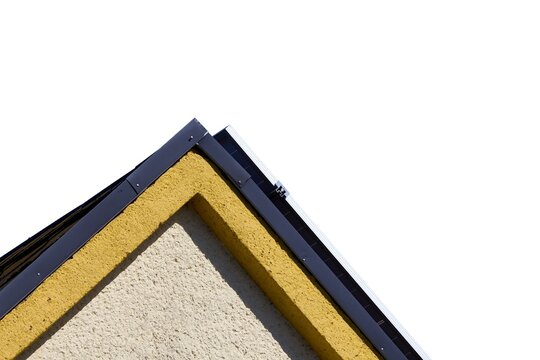 House gable peak with yellow plaster and unpainted grey cement patch isolated on a white background