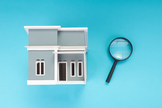 High Angle of Miniature Building and Magnifying Glass for Investment Analysis