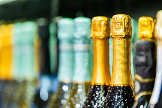 Colorful champagne bottle collection with metallic foil tops. Celebration, luxury beverage, festive party, wine shop, hospitality
