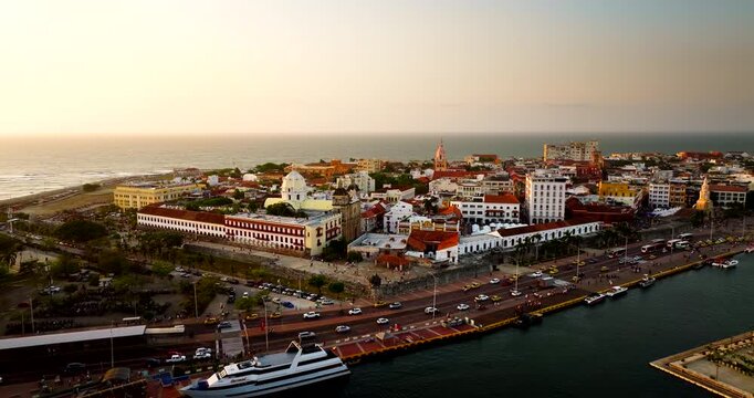 Historic Cartagena City centre and Santuario de San Pedro Claver overlooking the Caribbean waterfront at sunset, aerial view