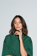 Fototapeta premium Natural beauty portrait of woman with shoulder length hair in green shirt for fashion background banner and lifestyle design