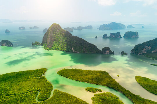 Rivers and streams with muddy waters among the mangrove forests of the Andaman Sea against the backdrop of limestone cliffs