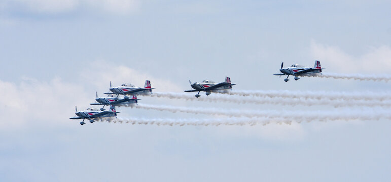 Team Raven, flying Aircraft in formation with white smoke trails