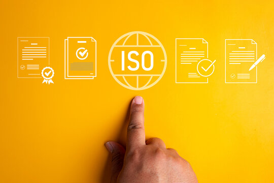 Finger pointing at ISO standard globe symbol surrounded by certified document and contract icons on bright yellow background