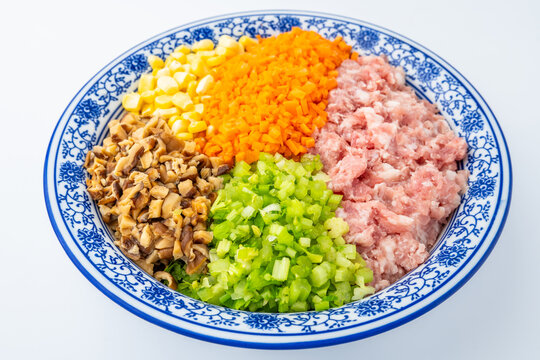 A bowl of pork, vegetable, and mushroom dumpling filling