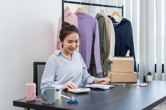 Female fashion designer is calculating the cost of new fashion c