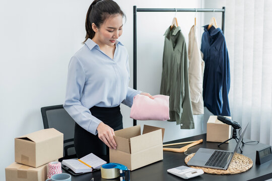 Female fashion designer is checking order customer on laptop and