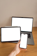 Connected devices with blank screens including smartphone, laptop and tablet, creating a modern technology concept for apps, websites and digital business © Anna