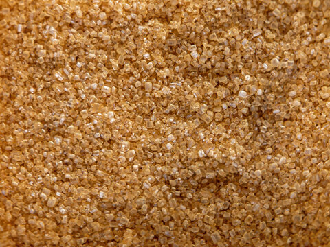 Organic healthy crystal brown cane sugar food texture background