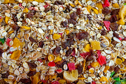 Surface of healthy granola organic breakfast cereals with dry fruits and whole grain oats