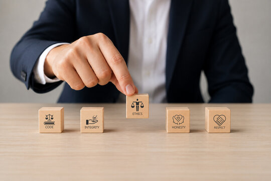Code of conduct in business concept. Wooden blocks with code of conduct icons%3B code  integrity  honesty  respect  and ethics  the foundation of a strong corporate code of conduct. Corporate ethics.