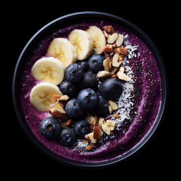 Fresh acai bowl with banana, berries, and nuts isolated on black backdrop with clipping path, symbolizing healthy nutrition