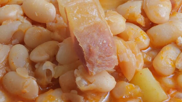 dish of cooked white beans with chorizo ​​and bacon