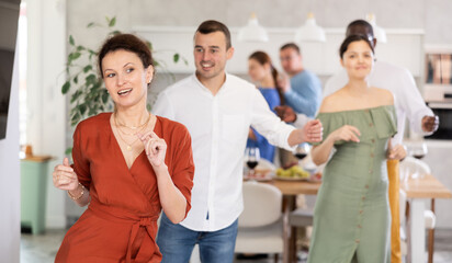 Fototapeta premium Multicultural men and women friends enjoying active dancing