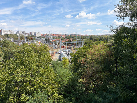Electrical power substation viewed through trees in an urban residential landscape