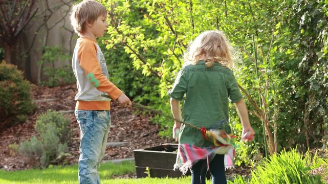 Happy children, siblings, enjoying Easter holiday together, tradition with handmade twig, braided whip made from pussy willow, traditional symbol of Czech Easter