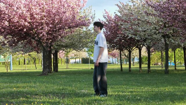 Happy children, teenage boys, playing jumping game in the park, springtime