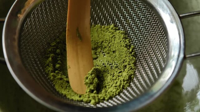 Barista preparing traditional matcha using setting. The scene highlights the careful preparation process, vibrant green matcha, and Japanese-inspired tea culture, making it suitable for beverage, caf&eacute;