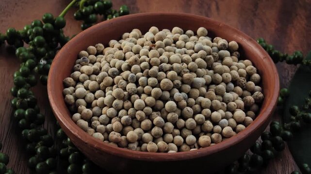 White peppercorns in a bowl	