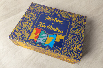 Fototapeta premium Calgary, Alberta, Canada. August 25, 2026. High angle view of a Harry Potter x Tim Hortons promotional decorative box on a wooden surface.