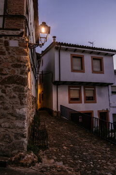 Atmospheric Cobblestone Alley with Glowing Street Lamp in Historic Spanish Mountain Village