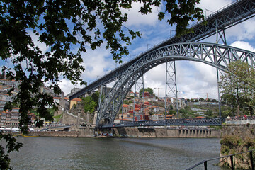 Fototapeta premium View of the historic city of Porto, Portugal with the Dom Luis bridge and blue sky Panoramic view from the city of Porto in Portugal Ancient city Porto,metallic ...