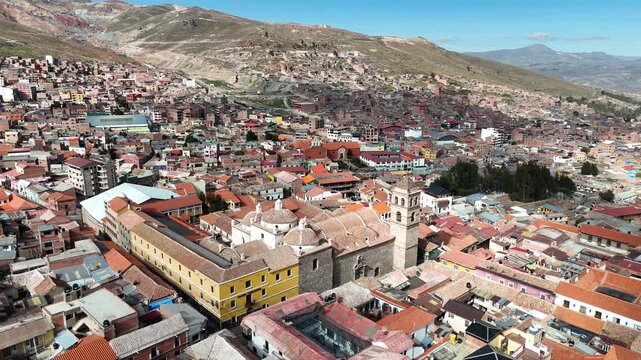 High-angle cinematic footage over the historic center of Potosi, capturing the endless sea of traditional terracotta roofs in Bolivia.