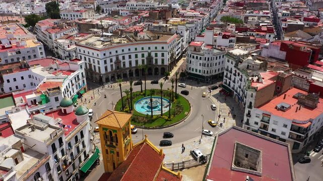 Aerial view of Grand Socco in Tangier, showing the circular square, fountain, historic white architecture and surrounding streets in the vibrant city center of Northern Morocco.