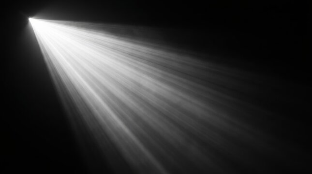 A single bright light beam illuminates the darkness from the upper left corner.