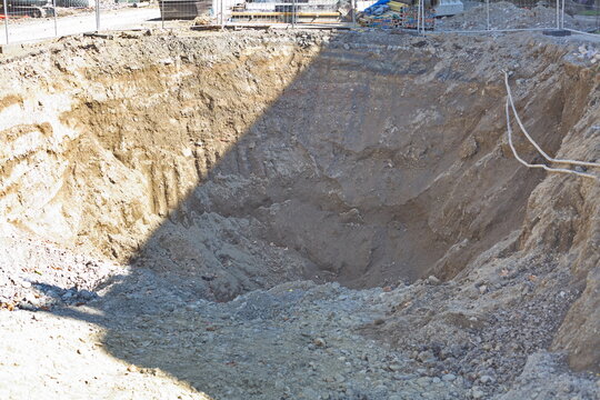 Deep excavation pit at construction site