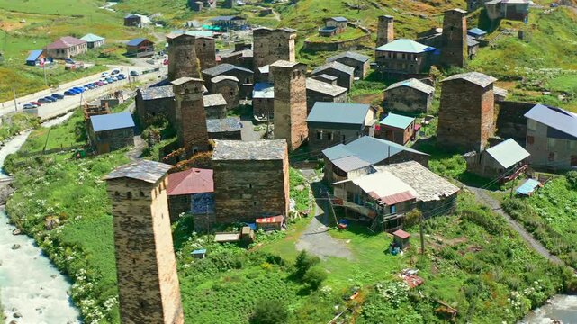 Chazhashi settlement passes in circling aerial view beside the Enguri River and patchwork fields, supporting cultural landscape research, UNESCO heritage tourism and traditional land-use documentation
