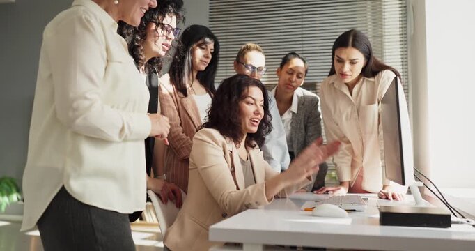 Women team meeting with leader and collaboration. They gather around a computer in bright office for discussion and planning, sharing ideas and aligning goals. Strong strategy with team focus.