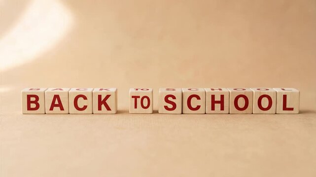 Back to school words made with wooden blocks and hand placing cube for education preparation concept on clean background.