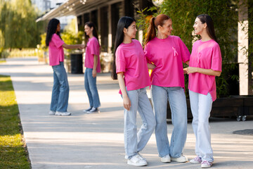 Fototapeta premium Diverse women wearing pink ribbons supporting breast cancer awareness