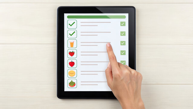 Salmonella and FDA concept ,Finger pointing food safety checklist on digital tablet screen with icons