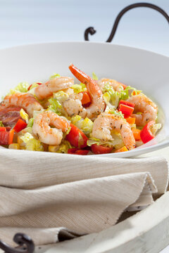 Bowl of scampis with fresh mixed salad, close up