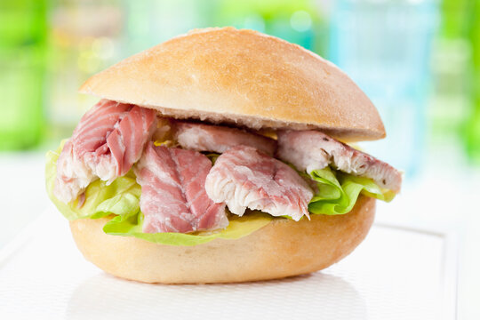 Bread roll with pieces of eel, close up