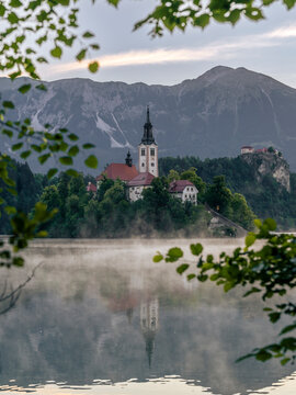 Mist covers Lake Bled with the pilgrimage church in Slovenia