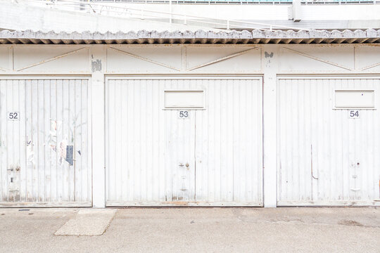 Row of three white garage doors