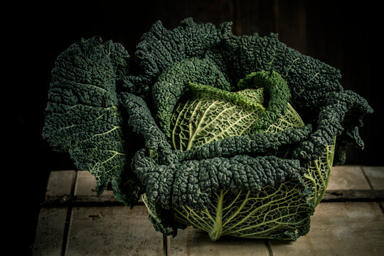 Savoy cabbage against black background