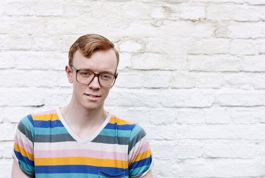 Young man wearing glasses looks at the camera in Berlin