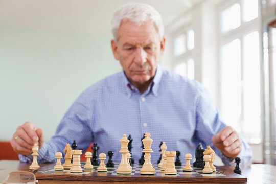 Male plays a chess game indoors at an apartment community