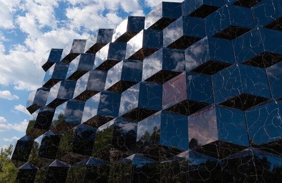 Futuristic Hexagonal Glass Facade Reflecting Blue Sky and Trees &mdash; Geometric Architecture Concept