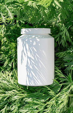Empty white plastic container without label lies among dense green foliage, contrasting summer shadows. Mockup for brand of natural cosmetics, dietary supplements, sports nutrition