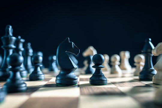 Chess pieces on chess board knight and pawn stand off, competition, planning and strategy