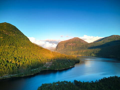 Aerial view of turquoise glacial lake surrounded by Norwegian mountains