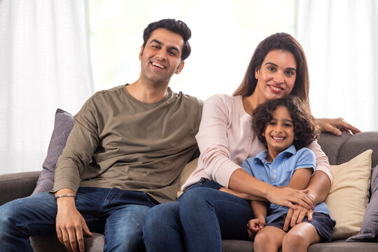 Portrait of a happy parent with kid looking together at camera with smile