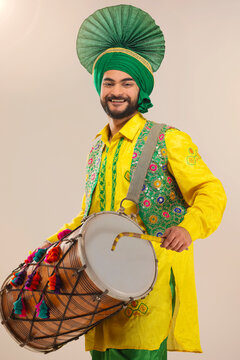 Portrait of Sikh man playing drum during Baisakhi celebration
