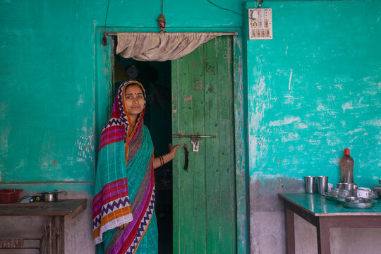 rural woman standing in front of door