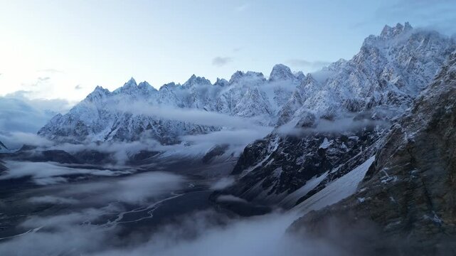 Aerial drone flyover of steep glacial ravines and rocky mountain walls near Fairy Meadows Base Camp in Hunza Valley, Pakistan. Rugged terrain